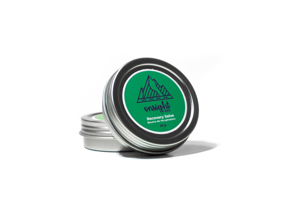 green labeled recovery salve tin standing upright