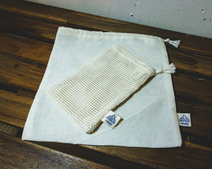 Cotton bulk bag with soap saver bag on top wood table.
